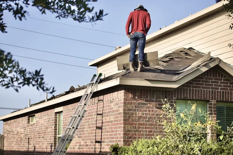 Professional roofer working on a residential roof in Saybrooke Village
